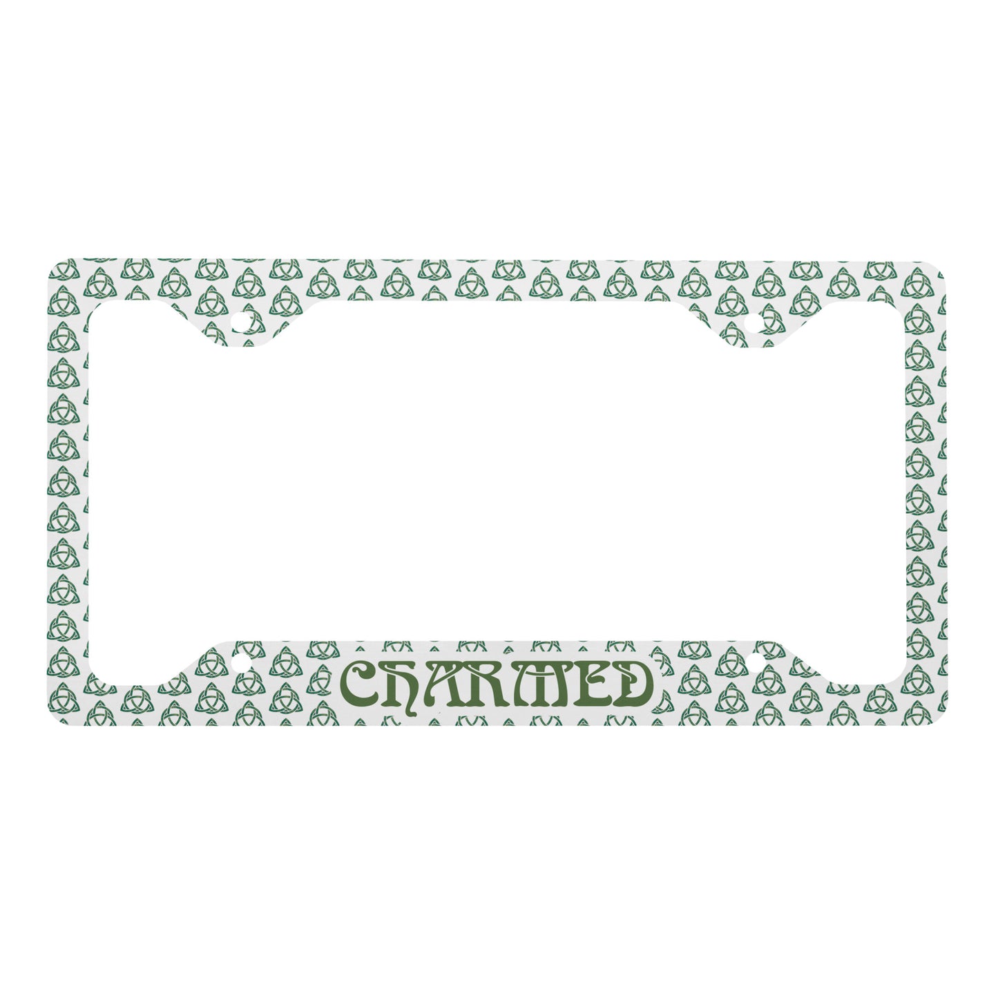 White metal license plate frame with green Celtic knot pattern and "CHARMED" lettering at bottom center.